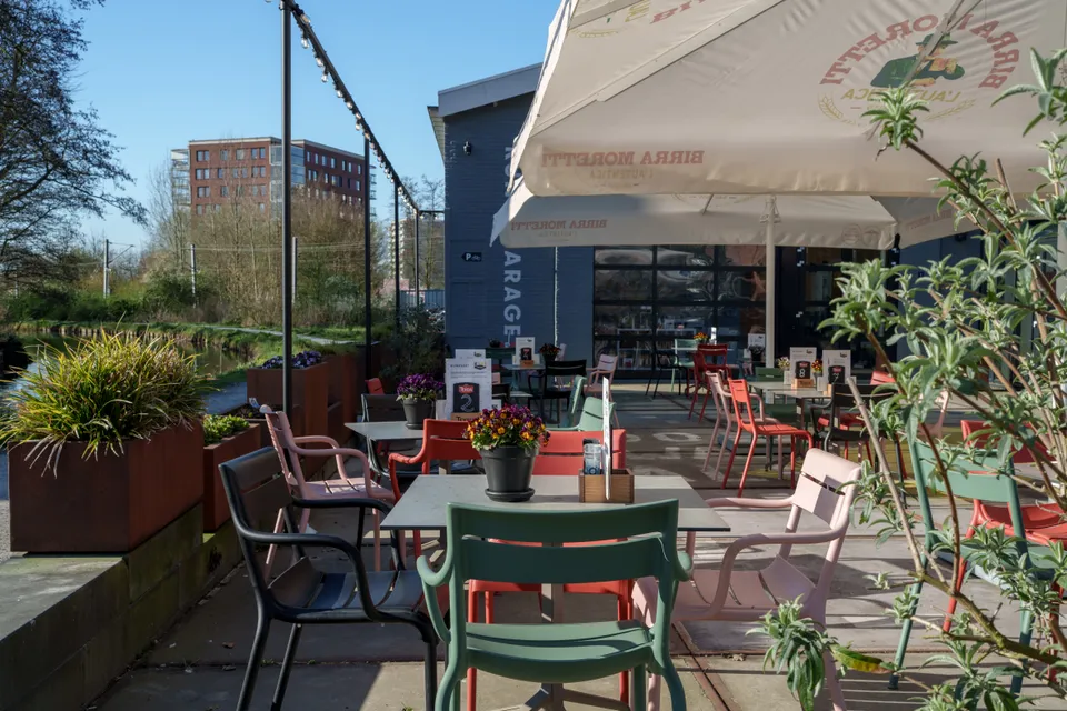 Kiki’s terras met kleurrijke stoelen, bloemen en parasols